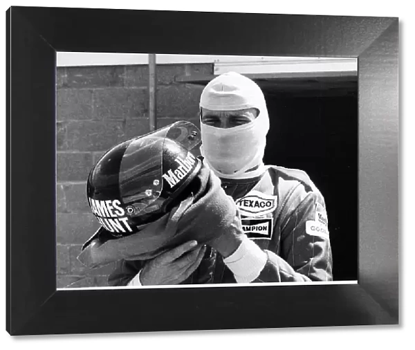 James Hunt racing driver puts on crash helmet in 1976