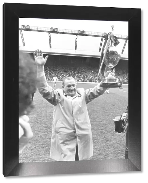 Liverpool Manager Bob Paisley holding up the League Championship trophy to the Anfield