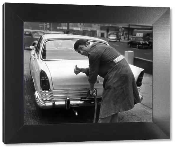 Manchester Uniteds David Herd, pictured filling up a car at his garage in Urmston
