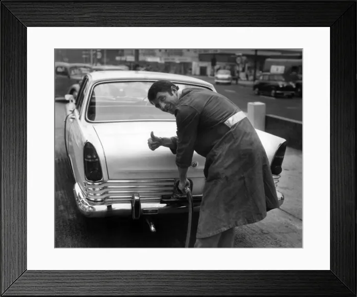 Framed Print : Manchester Uniteds David Herd, pictured filling up a car at his garage in Urmston