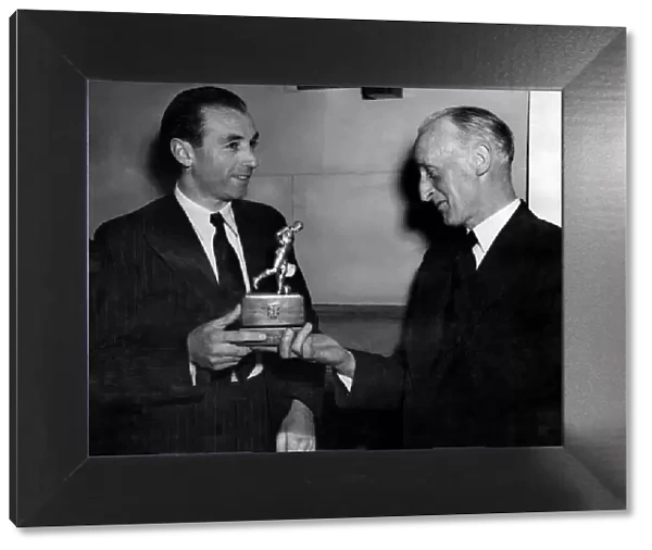 Stanley Matthews, Blackpool and England right winger, being presented with a bronze