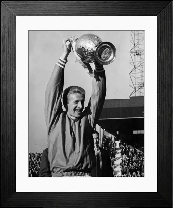 Framed Print : Manchester United v Strasbourg. Bottoms up as skipper Denis Law holds aloft the League Framed Print : Manchester United v Strasbourg. Bottoms up as skipper Denis Law holds aloft the League