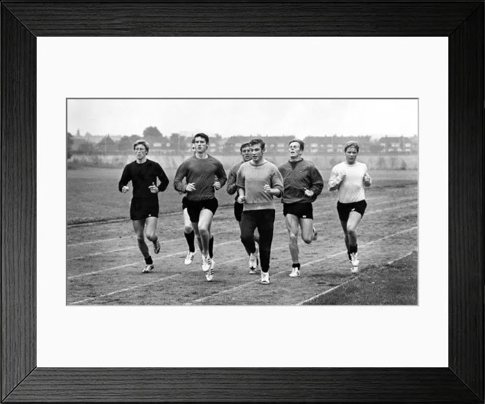 Framed Print : John Davies (centre) leads the Manchester City players in their training stint
