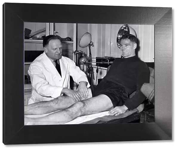 Billy Liddell, gets a massage from Albert Shelley, trainer, after his morning training