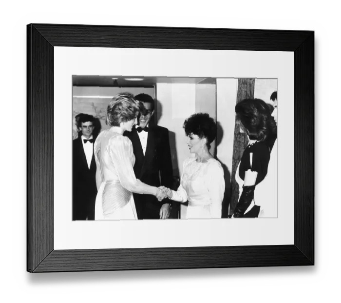Framed Print : Princess Diana shakes hands with actress Joan Collins at a Bruce Oldfield London fashion