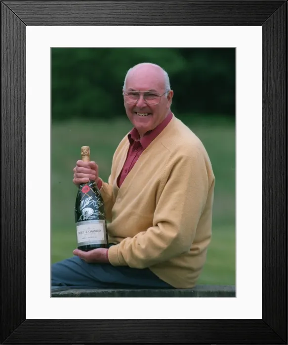 Framed Print : Murray Walker Motoracing Commentator July 1997 holding bottle of champagne