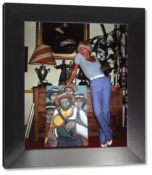 Elke Sommer, actress inside a house standing next to a painting sex