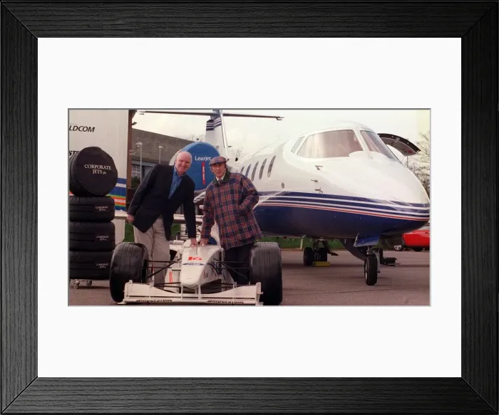 Framed Print : Tom Hunter with Jackie Stewart March 1999 with a race car with the new Lear Jet Framed Print : Tom Hunter with Jackie Stewart March 1999 with a race car with the new Lear Jet