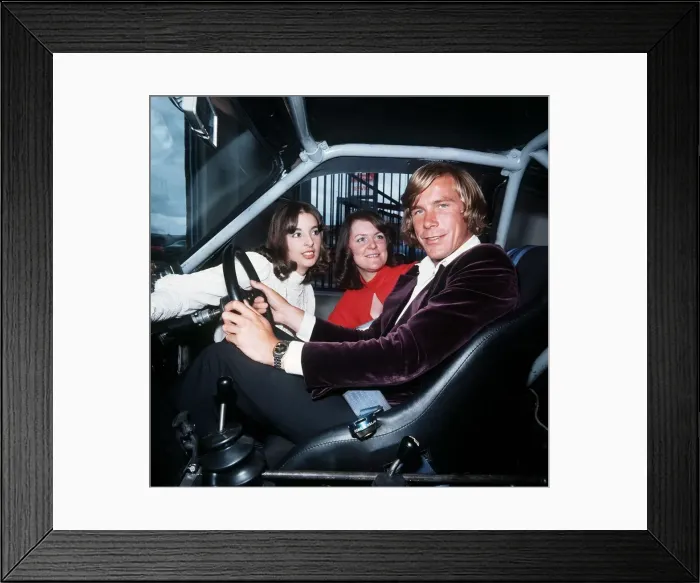 Framed Print : James Hunt racing driver 1976 at driving seat of car with female fans Framed Print : James Hunt racing driver 1976 at driving seat of car with female fans