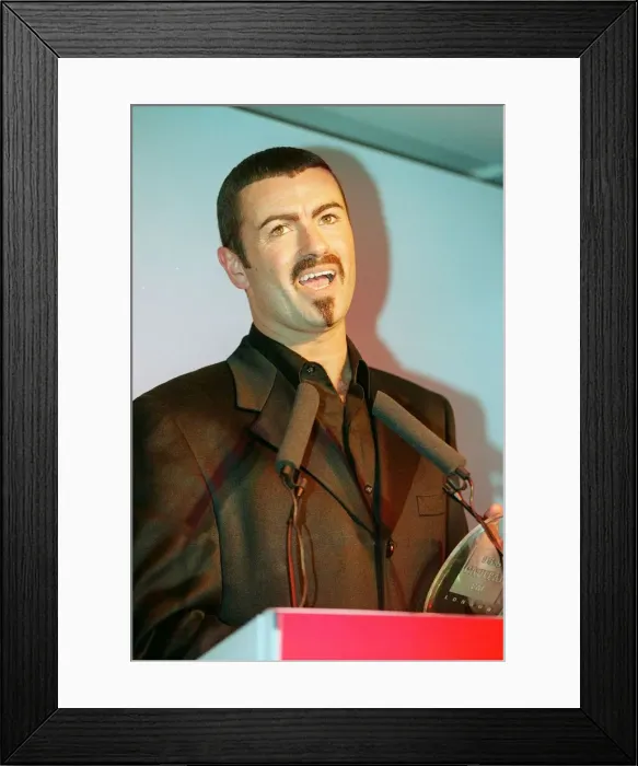 Framed Print : George Michael the singer collects his award at the Help A London Child