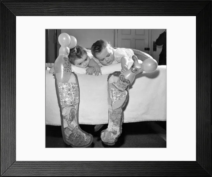 Framed Print : Twins Sandra and Valerie Simpson seen here with their Christmas stocking December Framed Print : Twins Sandra and Valerie Simpson seen here with their Christmas stocking December