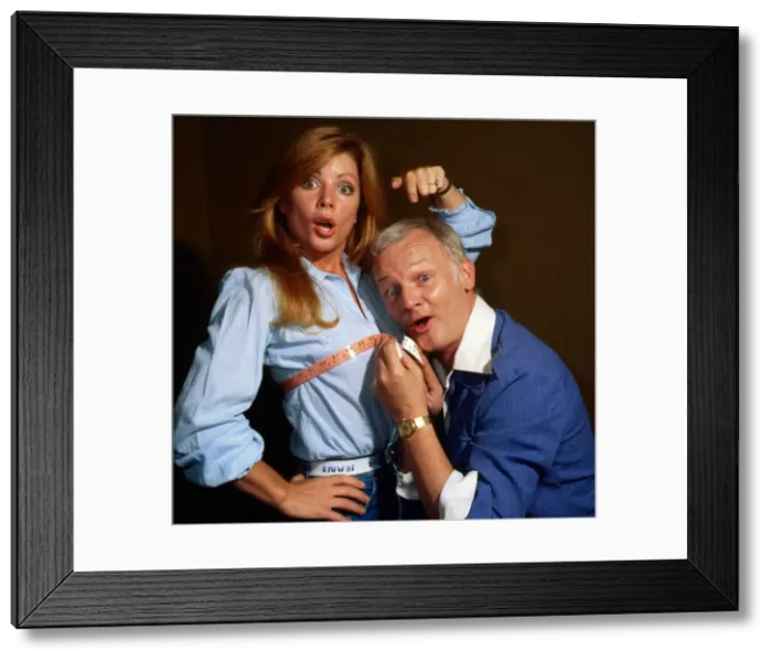 Framed Print : John Inman measuring Penny Irving August 1979 Framed Print : John Inman measuring Penny Irving August 1979