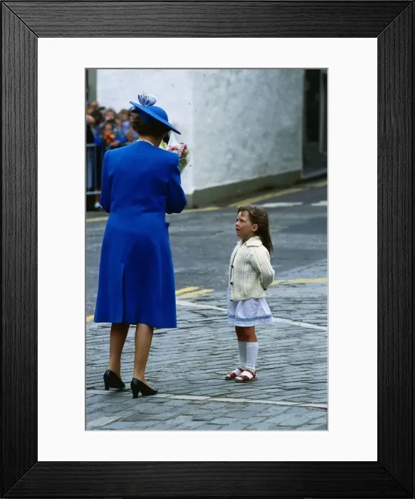 Framed Print : Queen Elizabeth II July 1989 taking flowers from a little girl who is looking up At her Framed Print : Queen Elizabeth II July 1989 taking flowers from a little girl who is looking up At her