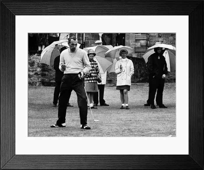 Framed Print : Max Faulkner contemplates his putt at the British Golf Open as spectators keep dry with Framed Print : Max Faulkner contemplates his putt at the British Golf Open as spectators keep dry with