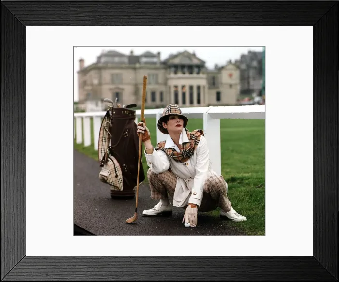 Framed Print : Golf Fashion woman crouching down next to golf bag clubs Burberry type checked hat Framed Print : Golf Fashion woman crouching down next to golf bag clubs Burberry type checked hat