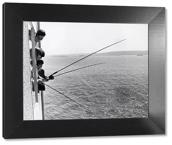 The Beatles do a spot of fishing from their hotl room in Seattle Washington 22nd August