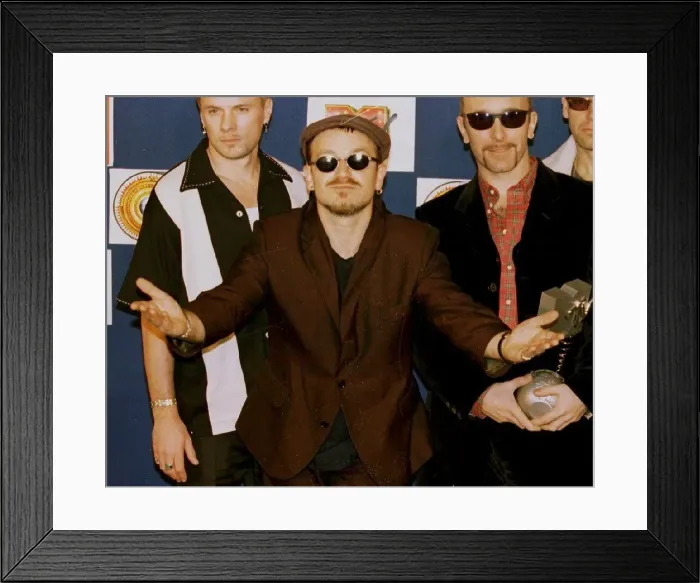 Framed Print : Bono, lead singer of Irish rock group U2, looks bemused after his band received the Best Framed Print : Bono, lead singer of Irish rock group U2, looks bemused after his band received the Best