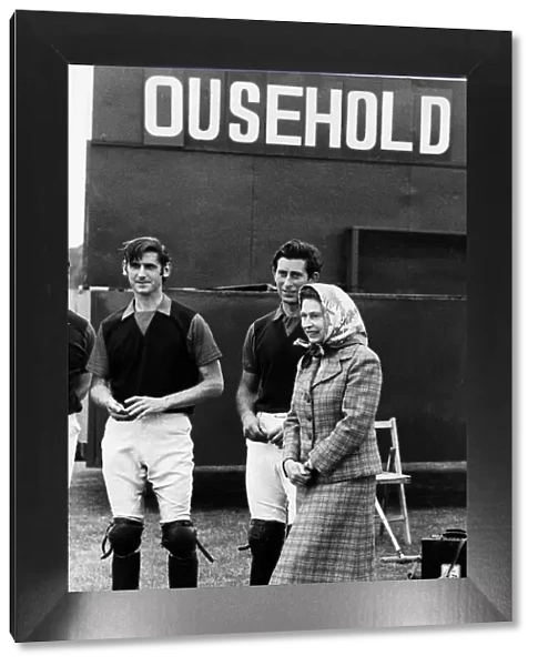 Queen Elizabeth II and Prince Charles June 1979 laugh at the score board at a polo