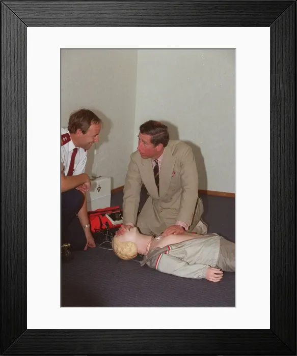 Framed Print : Prince Charles getting up close and personal with a resussitation dummy