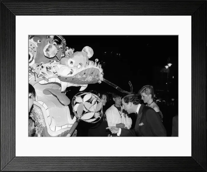 Framed Print : Prince Charles and Princess Diana observing a Chinese dragon as they attend the premier