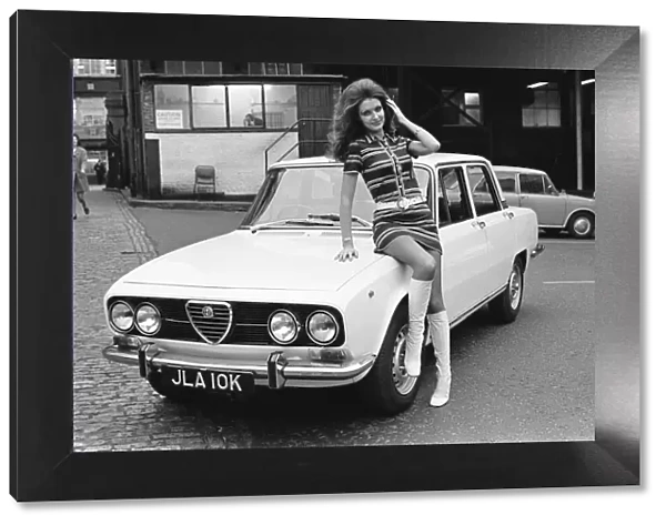 Reveille model seen here posing with a Alfa Romero car which is top prize in the Reveille