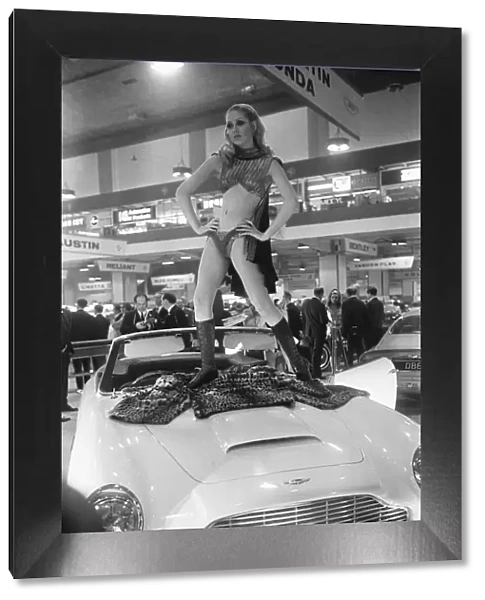 Model poses on the bonnet of a Aston Martin Volante at Motor Show 15th October 1968