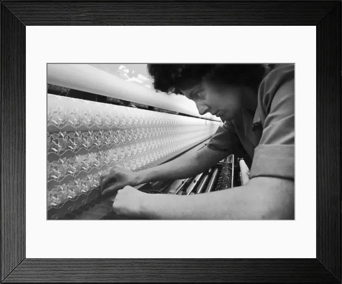 Framed Print : Loom operator seen here making fine adjustments to the loom at the Ulster Lace Company