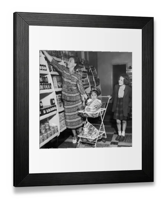 Framed Print : Mrs Freda Fox seen here selecting a jar of jam from the shelves of the new self service Framed Print : Mrs Freda Fox seen here selecting a jar of jam from the shelves of the new self service