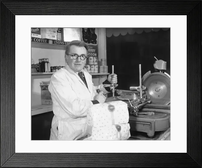 Framed Print : Shopkeeper Kenth Shiel seen here slicing some bacon for a customer 1st January 1954 Framed Print : Shopkeeper Kenth Shiel seen here slicing some bacon for a customer 1st January 1954