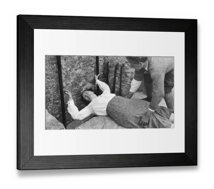 Framed Print : A women seen here with the aid of her gentleman friend kissing the Blarney stone