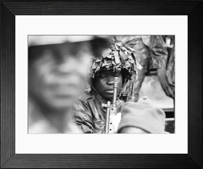 Framed Print : A Nigerian army soldier tries to catch 40 winks in the back of the lorry going to Framed Print : A Nigerian army soldier tries to catch 40 winks in the back of the lorry going to