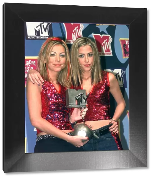 Sisters Natalie Appleton and Nicole Appleton of pop group All Saints pick up their award