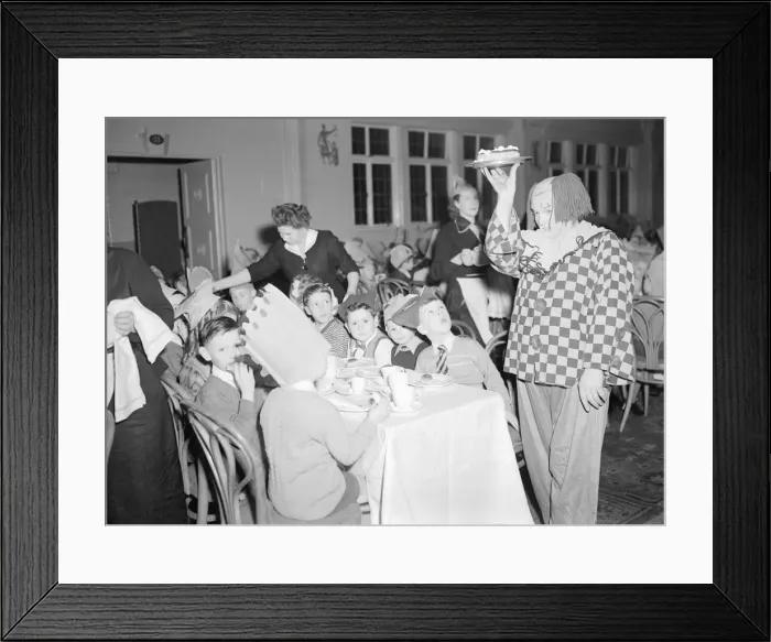 Framed Print : A clown helps out the waitresses at the yearly Daily Mirror Christmas Childrens Party Framed Print : A clown helps out the waitresses at the yearly Daily Mirror Christmas Childrens Party
