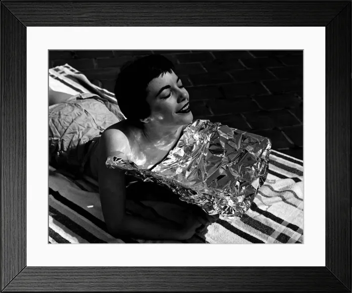 Framed Print : A young woman catching some rays whilst on holidays June 1954 Framed Print : A young woman catching some rays whilst on holidays June 1954