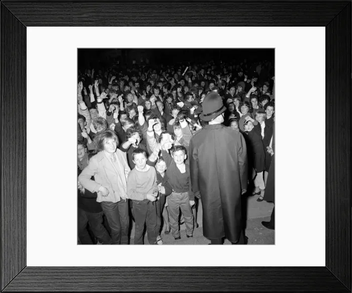 Framed Print : The Beatles November 1963 A policeman stands guard as fans of The Beatles cheer Framed Print : The Beatles November 1963 A policeman stands guard as fans of The Beatles cheer