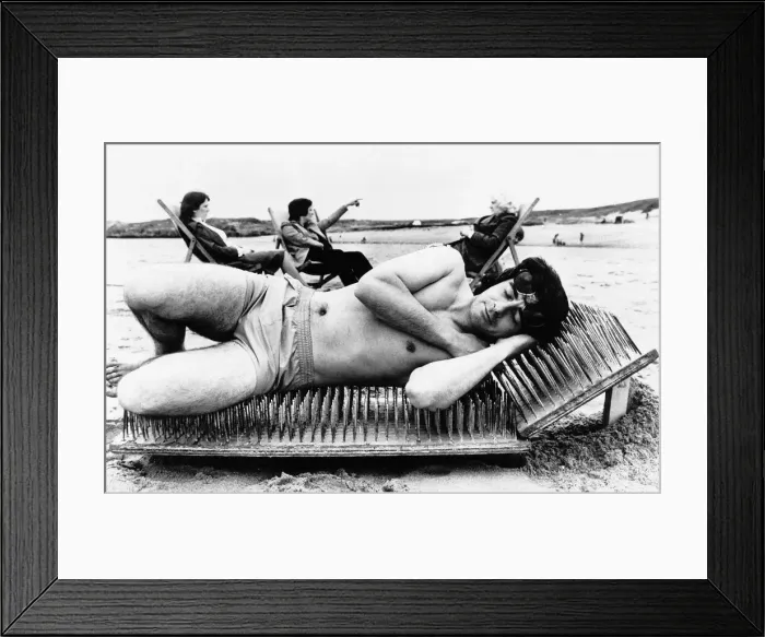 Framed Print : Stunts man lies on sunbed of nails on the beach Unknown date Framed Print : Stunts man lies on sunbed of nails on the beach Unknown date