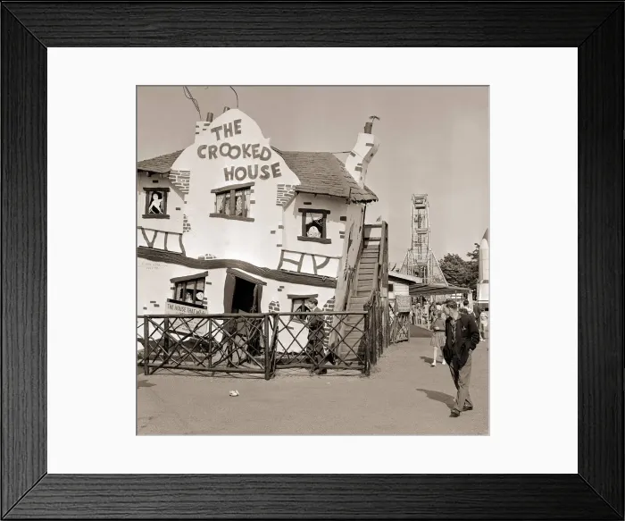 Framed Print : Holiday Resorts at Southend in Essex A man walks by a themed house called Framed Print : Holiday Resorts at Southend in Essex A man walks by a themed house called