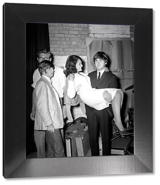 Paul McCartney holding Cherry Rowland as Ringo Starr watches at the Futurist theatre in