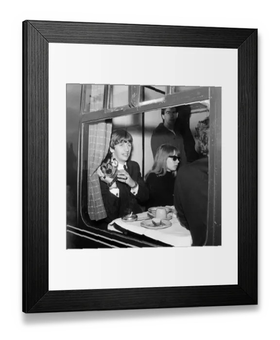 Framed Print : Ringo Starr with a cine camera and an actress in his compartment with the Beatles Framed Print : Ringo Starr with a cine camera and an actress in his compartment with the Beatles