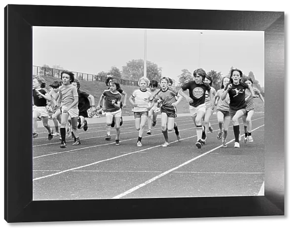 Boys and girls take part in a race at their school sports day. 20th June 1979