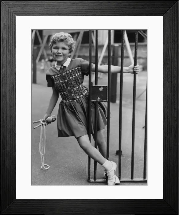 Framed Print : Girl seen here playing with skipping rope. She is wearing a dress which is similar to Framed Print : Girl seen here playing with skipping rope. She is wearing a dress which is similar to