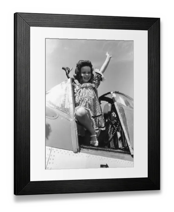 Framed Print : Come Fly With Me. Little Lucy Deplidge seen here waving from the cockpit of a Fleet Air Framed Print : Come Fly With Me. Little Lucy Deplidge seen here waving from the cockpit of a Fleet Air
