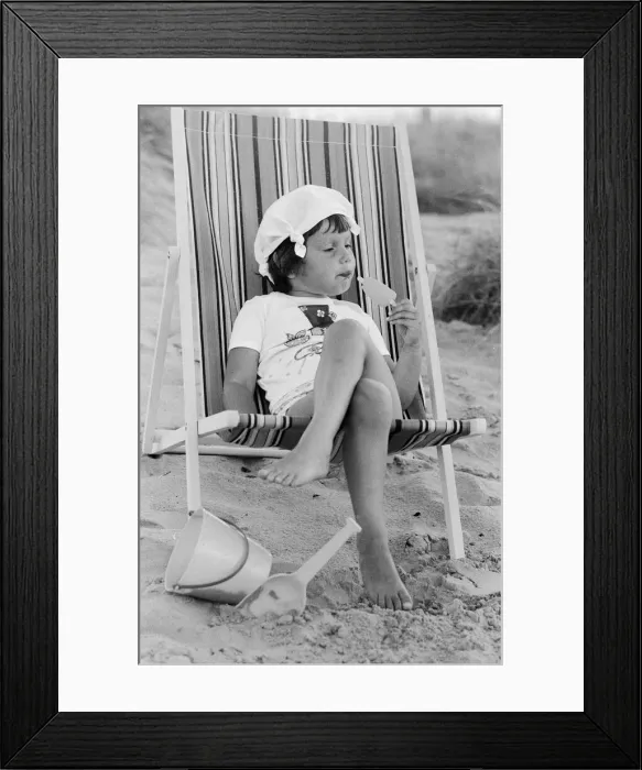 Framed Print : Four year old Joanna Weaver of Fordcombe, Kent enjoys an ice lolly as she sits in a deck