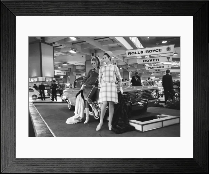 Framed Print : Models pose by the bonnet of a Plymouth car at the British International Motor Show in