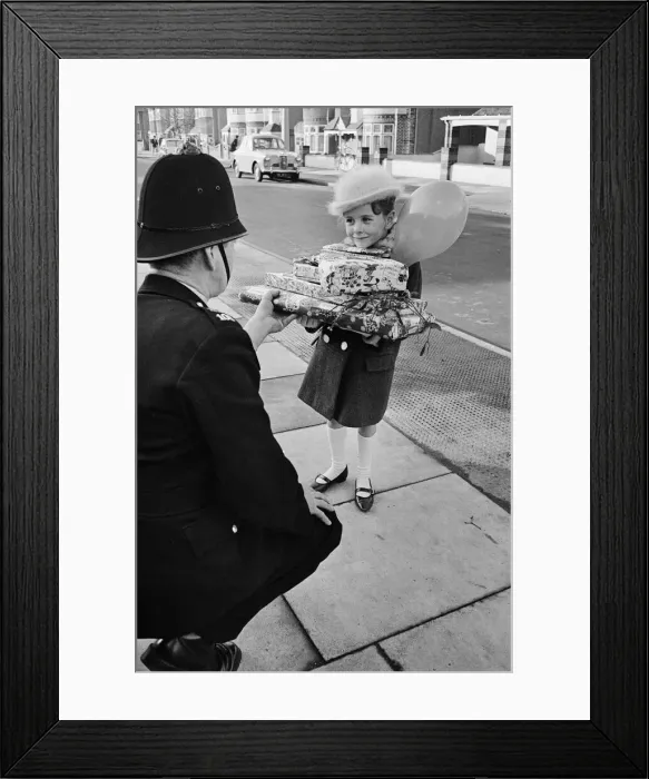 Framed Print : Young Susan Burton holding a pile pf Christmas presents Framed Print : Young Susan Burton holding a pile pf Christmas presents
