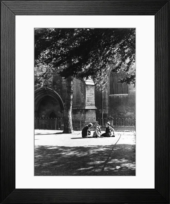 Framed Print : Childhood confidences in the playground of the girls school beside the walls of Tewesbury