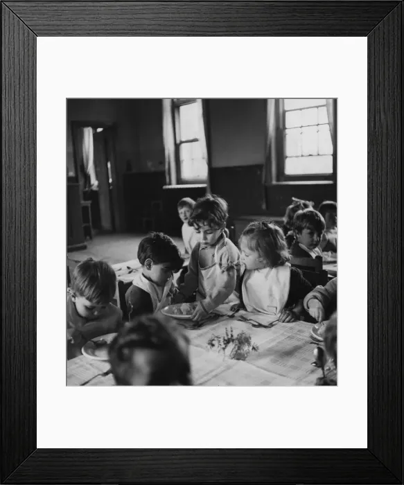 Framed Print : One of the schoolchildren helping to serve school dinners at the London County Framed Print : One of the schoolchildren helping to serve school dinners at the London County