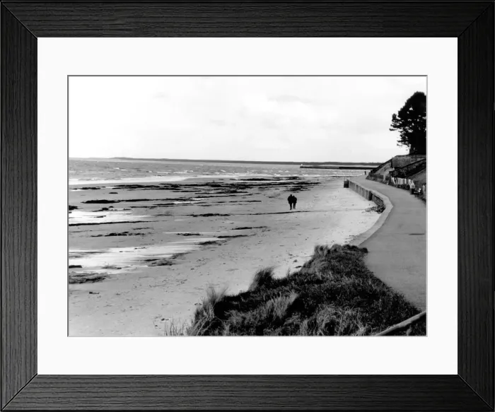 Framed Print : A couple take a stroll along Nairn beach in Scotland. Circa 1970 Framed Print : A couple take a stroll along Nairn beach in Scotland. Circa 1970