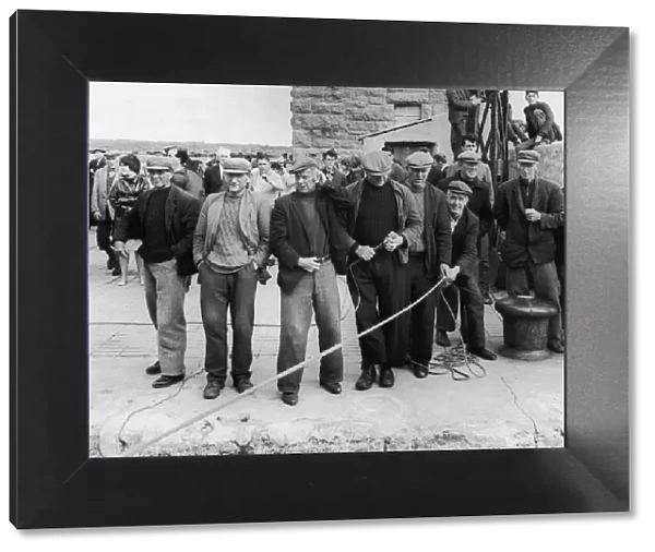 Kindly, tough men, Aran Islanders gather on the quayside to throw a line as the ferry