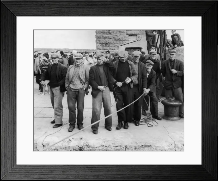 Framed Print : Kindly, tough men, Aran Islanders gather on the quayside to throw a line as the ferry